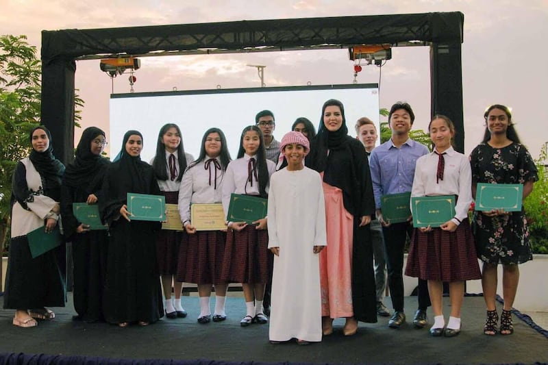 Sheikh Mohammed bin Diab Al Nahyan, centre, with Ameera Amir, Founder of Lahum, and scholarship recipients. Courtesy Ameera Amir