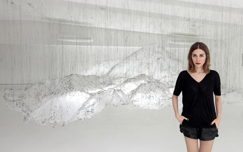 Sanaz Askari, the founder of The Mine, stands in front of an installation by Yasuaki Onishi in the gallery. Jeffrey E Biteng / The National