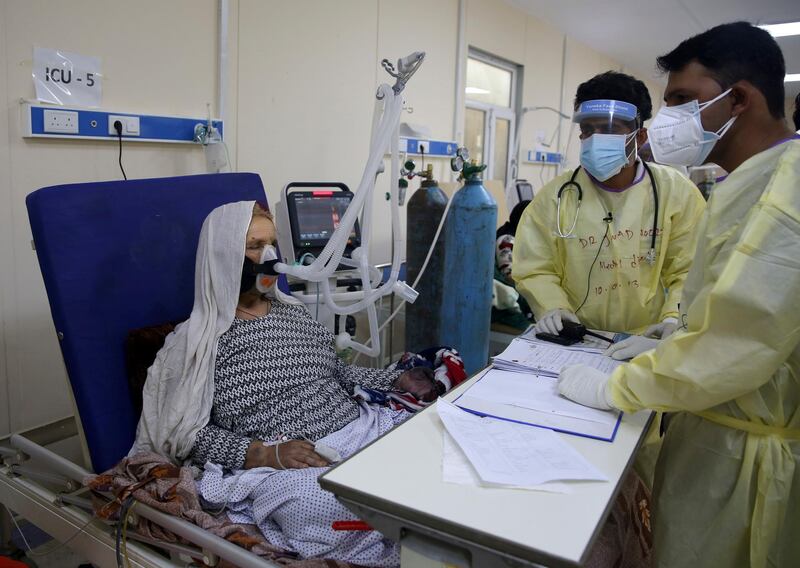 Afghan doctors help a patient to breathe through an oxygen mask in the Intensive Care Unit (ICU) ward for Covid-19 patients at the Afghan-Japan Communicable Disease Hospital in Kabul, Afghanistan. All photos by Rahmat Gul / AP Photo