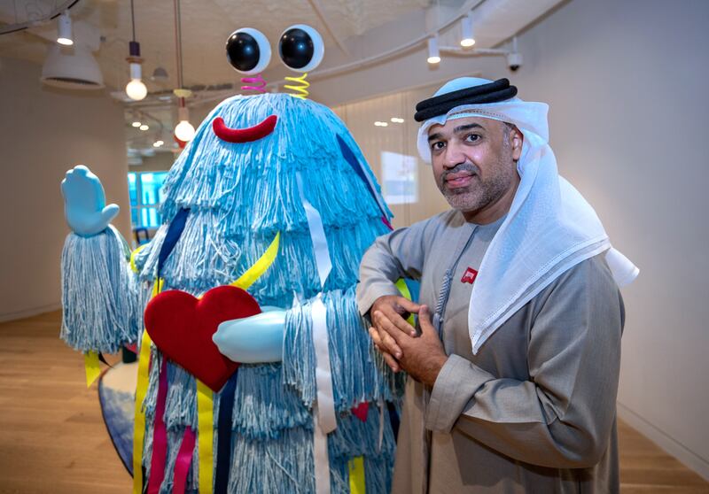 Thamer Rasher Al Qasimi, executive director of special projects and partnerships at the Early Childhood Authority, with a colourful office mascot. All photos: Victor Besa / The National