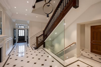 Chequered marble flooring and the grand central staircase in the entrance hall. Photo: Beauchamp Estates