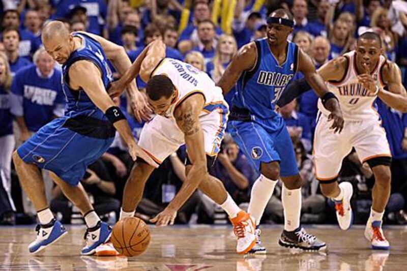 Jason Kidd, left, of the Dallas Mavericks, and Thabo Sefolosha, centre, of Oklahoma City Thunder, battle during Game 3 on Thursday, which Oklahoma lost to waste a chance to take control of the series.