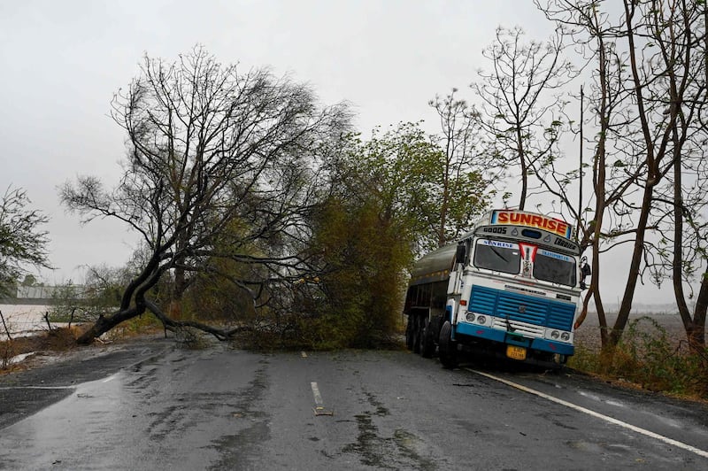 Downed trees and a stranded lorry on a motorway after cyclone Tauktae blew through Diu in south-western India. AFP