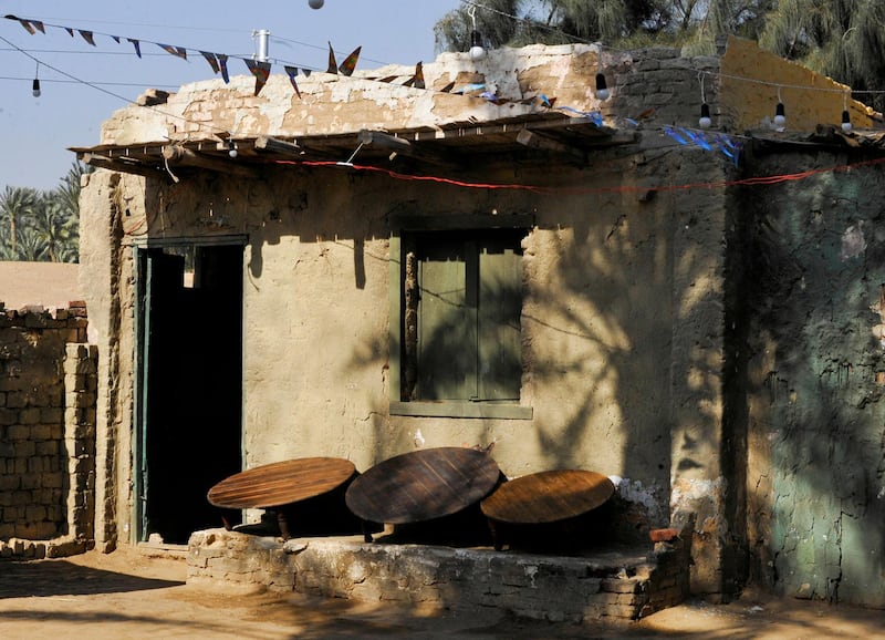 Tables are seen outside the house of a couple who try to improve their living conditions by selling food to tourists, in Saqqara village in Giza, Egypt, April 27, 2021. Picture taken April 27, 2021. REUTERS/Shokry Hussien