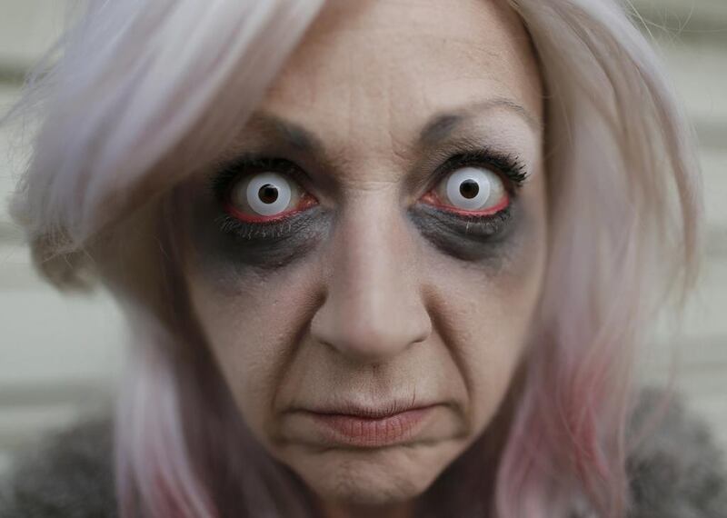 Project manager Yvonne Nagel poses for a photo while getting ready at Movie Park Germany in Bottrop October 25, 2013. Nagel, 38, will perform this year as the character 'Amanda Young' from the 'Saw' horror film series for the "Halloween Horror Party 2013" at Movie Park Germany.  Ina Fassbender / Reuters