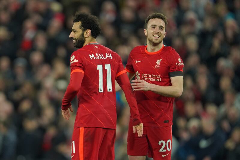 Liverpool's Mohamed Salah celebrates with Diogo Jota after scoring the fourth goal in the 4-0 rout of Manchester United at Anfield on April 19. AP