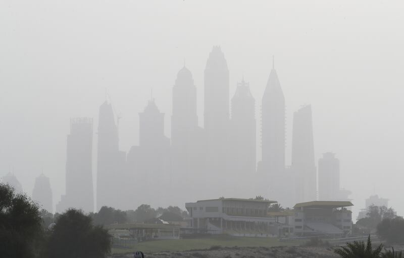 Towers in Barsha Heights are blanketed with dust on Monday evening. Weather forecaster the National Centre of Meteorology had issued a dust warning earlier in the day, advising people to take caution. Pawan Singh / The National