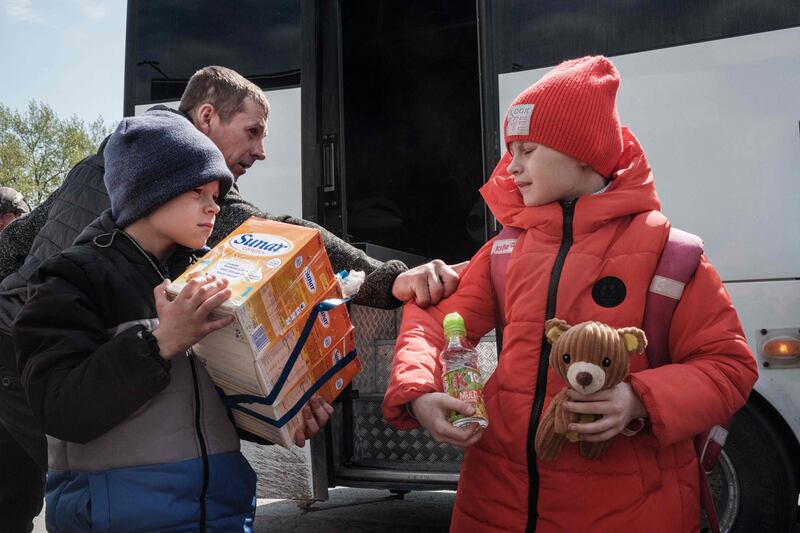 Nine-year-old Galina, right, and Nazar, 8, arrive with their families in Raihorodok. AFP