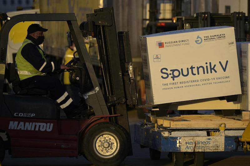 Shipping containers with Sputnik V vaccine are seen on board the Aerolineas Argentinas airplane at the tarmac of Ezeiza International airport in Buenos Aires province, Argentina. AFP