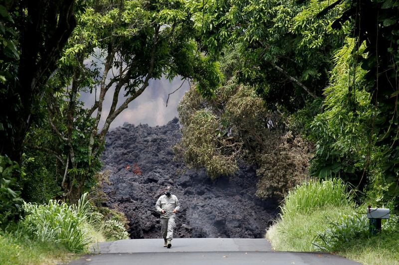 Lieutenant Colonel Charles Anthony, of the Hawaii National Guard, measures sulfur dioxide gas levels at a lava flow on Highway 137 southeast of Pahoa during ongoing eruptions of the Kilauea Volcano in Hawaii. Terray Sylvester / Reuters