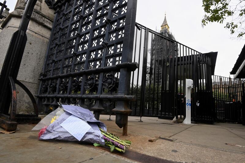 Flowers with a note for Sir David Amess lie outside Parliament buildings in London. Reuters