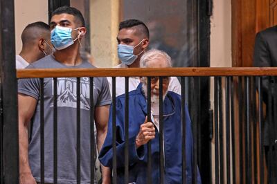 Mahmoud Ezzat, centre, the former supreme guide of Egypt's Muslim Brotherhood, in a Cairo court on Sunday. AFP