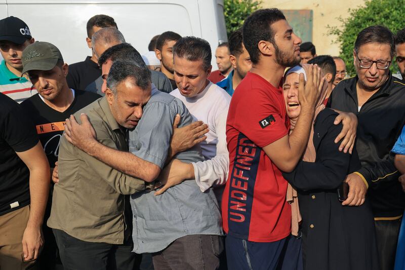 People mourn during the funeral of members of the Abu Morad family who died following Israeli strikes, in Khan Younis. AFP