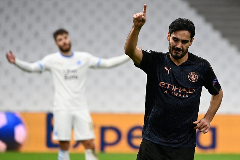 Manchester City's German midfielder Ilkay Gundogan (R) celebrates after scoring a goal during the UEFA Champions League Group C football match between Olympique de Marseille and Manchester City on October 27, 2020 at the Velodrome Stadium in Marseille. (Photo by CHRISTOPHE SIMON / AFP)
