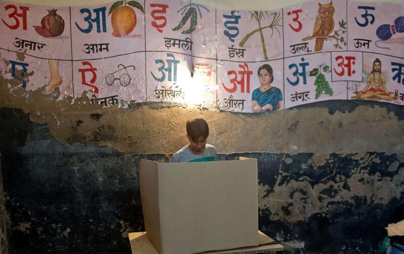 An Indian man casts his vote at a polling booth in Alwar. Prakash Sing / AFP Photo