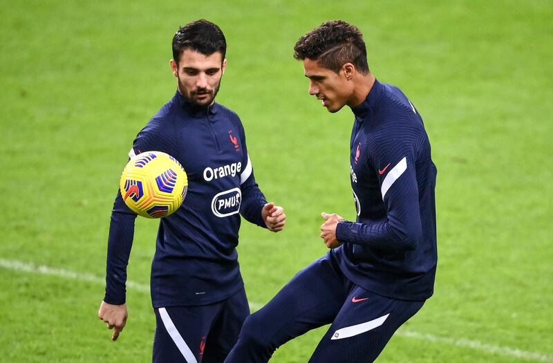 Raphael Varane (R) and Leo Dubois (L) take part in a training session at the Stade de France ahead of the Uefa Nations League match between France and Sweden. AFP