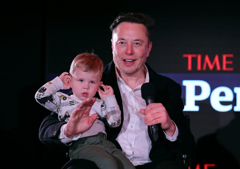 Mr Musk and son X Æ A-12 onstage at 'Time' Person of the Year in New York, in 2021 AFP