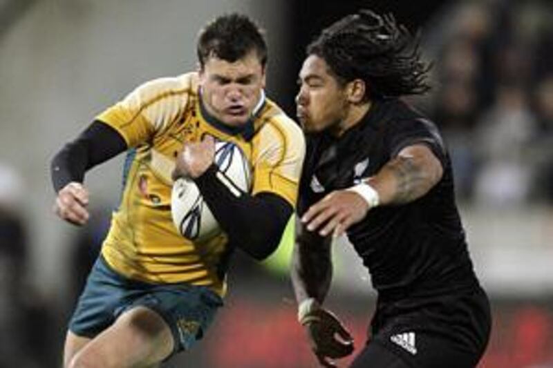 Ma'a Nonu, right, a try scorer for New Zealand, attempts to tackle Australia's Adam Ashley-Cooper.