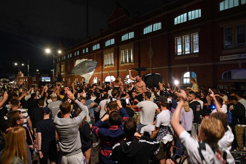 Fulham supporters gather outside Craven Cottage stadium. AFP