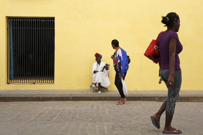 A street entertainer waits for tourists in Old Havana. The normalisation of ties between the US and Cuba could be a boon to the poor and isolated country. Desmond Boylan / AP Photo