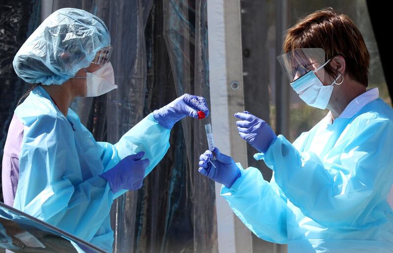 SAN FRANCISCO, CALIFORNIA - MARCH 12: Medical personnel secure a sample from a person at a drive-thru Coronavirus COVID-19 testing station at a Kaiser Permanente facility on March 12, 2020 in San Francisco, California. Kaiser Permanente has opened a drive-thru Coronavirus test station where patients who are exhibiting signs and symptoms of the Coronavirus can be referred by a physician to be tested. (Photo by Justin Sullivan/Getty Images)