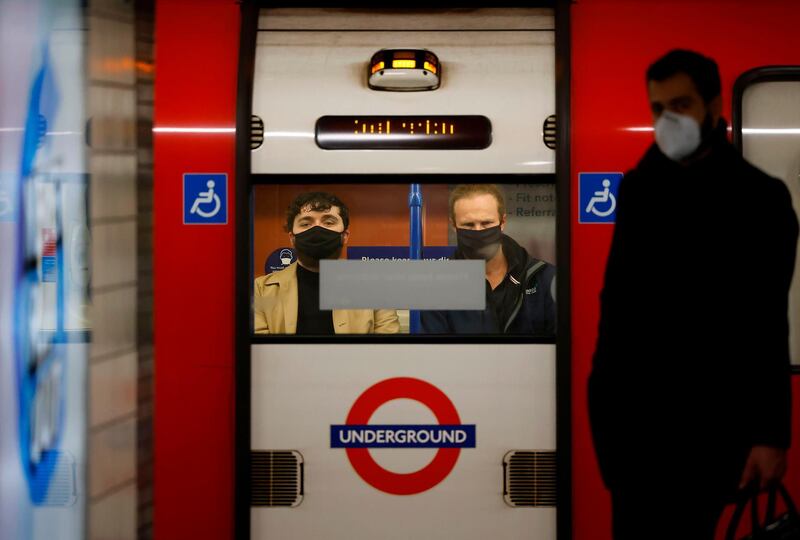 Passengers sit on a tube train during the morning rush hour in London. AFP