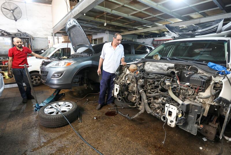 Mechanics work in a car repair garage, as Lebanon is gradually reopening its economy. Reuters