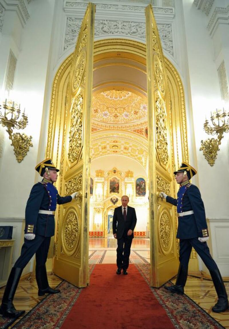 Russian President Vladimir Putin enters a hall to attend the presentation ceremony of the top military brass in the Kremlin in Moscow. Alexei Druzhinin / AP Photo / March 28, 2014