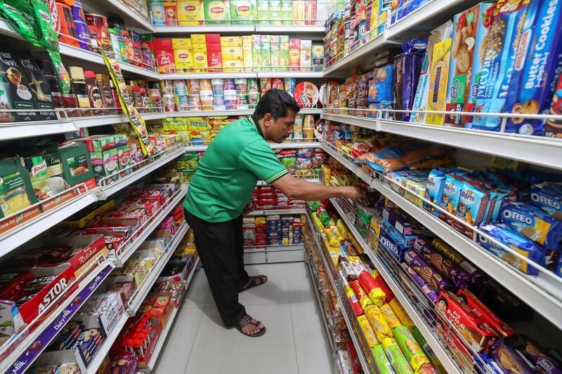 Abu Dhabi, United Arab Emirates - December 27th, 2017:  Workers at local shop Baqala to go with a story on VAT. Wednesday, December 27th, 2017 in Abu Dhabi. Chris Whiteoak / The National