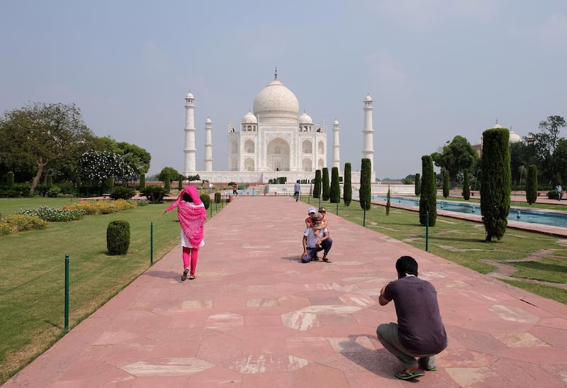 A man gets his photograph taken in front of Taj Mahal after authorities reopened the monument to visitors, amidst the coronavirus disease (COVID-19) outbreak, in Agra, India, September 21, 2020. REUTERS/Alasdair Pal