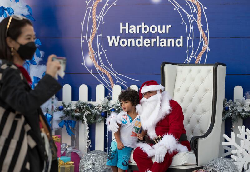 A child poses with Santa Claus at the Harbour Wonderland Christmas market at Dubai Harbour. All photos: Ruel Pableo for The National