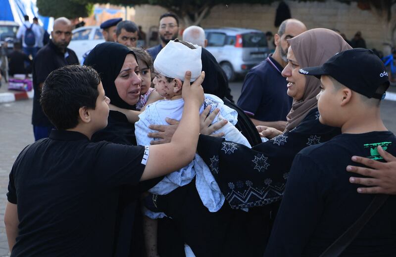 A woman hold a injured toddler following the Israeli bombardment of Deir Balah in the central Gaza Strip, at the Shuhada Al Aqsa hospital, on November 6 AFP