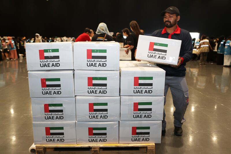 Volunteers prepare relief packages at the Festival City Arena in Dubai