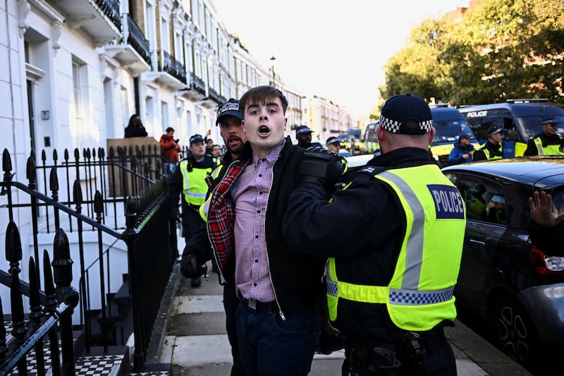 A man is detained by police officers on the day of a protest in solidarity with Palestinians in Gaza in London. Reuters