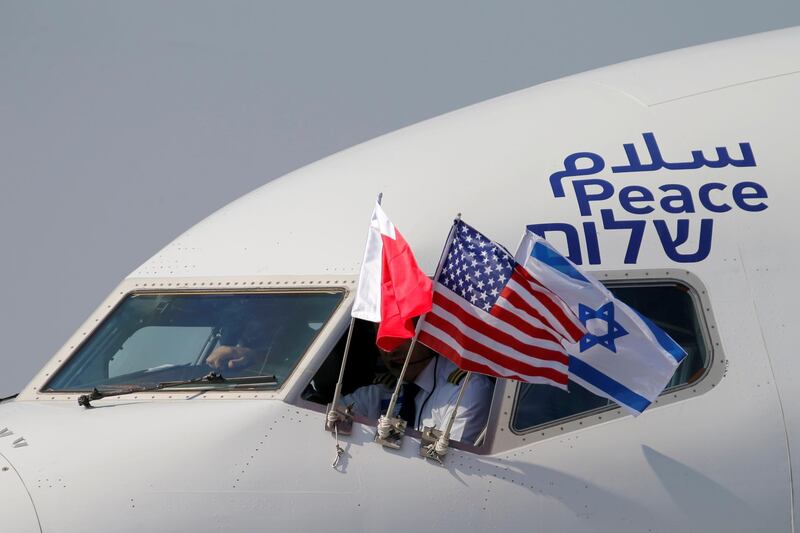 Bahraini, Israeli and US flags are seen on El Al's airliner carrying an Israeli delegation accompanied by the US treasury secretary as it lands in Bahrain.  Reuters