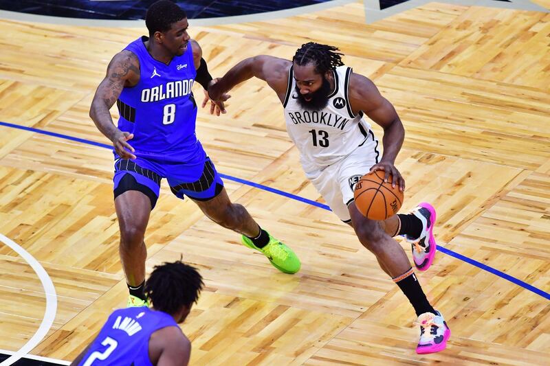 James Harden of the Brooklyn Nets drives to the basket against Dwayne Bacon of the Orlando Magic. AFP