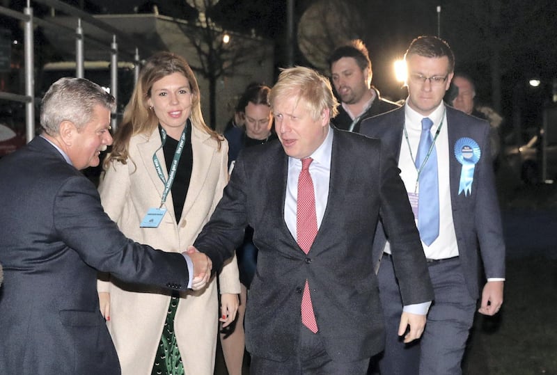 LONDON, ENGLAND - DECEMBER 13: Prime Minister Boris Johnson and his partner Carrie Symonds attend the vote count for his Uxbridge and South Ruislip constituency on December 13, 2019 in Uxbridge, England. Exit polls predicted the Prime Minister, who has held the Uxbridge and South Ruislip seat since 2015, will emerge from this general election with a governing majority, his aim when he called the first UK winter election for nearly a century. Election results from across the country are being counted overnight and an overall result is expected in the early hours of Friday morning. (Photo by Dan Kitwood/Getty Images)