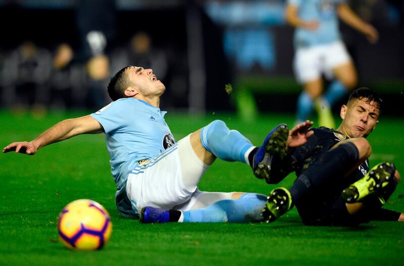 Celta Vigo forward Maxi Gomez, left, tussles with with Real Madrid defender Javi Sanchez. AFP