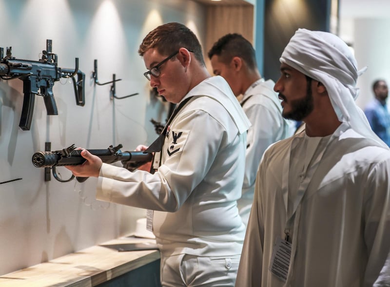 Abu Dhabi, U.A.E., February 20, 2019. INTERNATIONAL DEFENCE EXHIBITION AND CONFERENCE  2019 (IDEX) Day 4--  Colour images.-- Visitors at the show look at some Caracal firearms.
Victor Besa/The National
Section:  NA