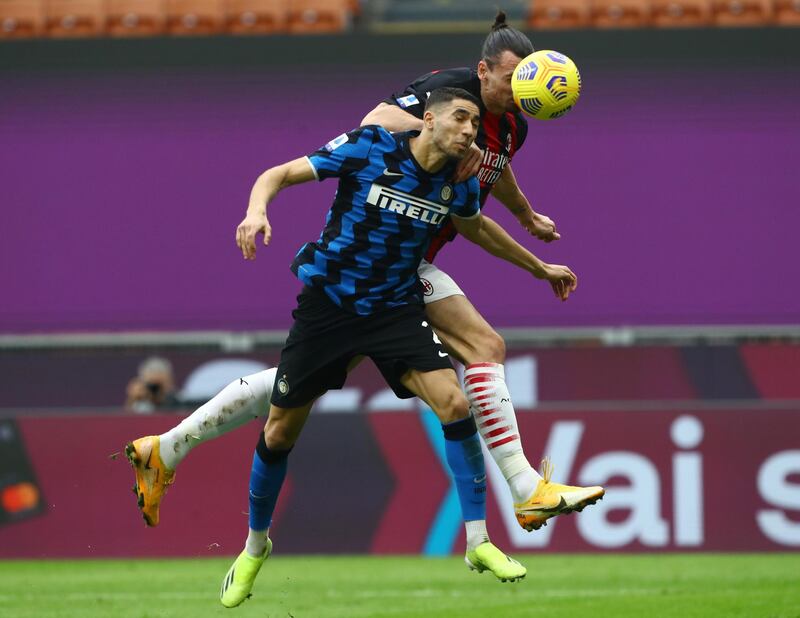 Inter's Achraf Hakimi battles for a header with Zlatan Ibrahimovic of AC Milan. Getty