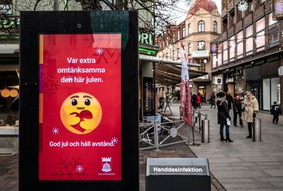 epa08868398 An information sign wishing Merry Christmas and asking to maintain social distancing is seen in a pedestrian shopping street in Helsingborg, southern Sweden, 07 Decmber 2020. The last week in November, Helsingborg had more new confirmed Covid-19 cases than in any other city in Sweden.  EPA/Johan Nilsson SWEDEN OUT