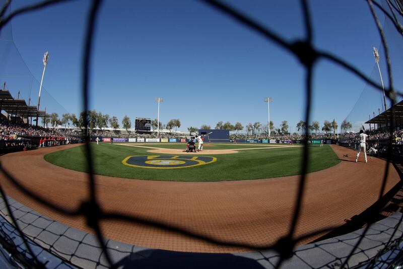 Milwaukee Brewers' Logan Morrison hits against Cincinnati Reds pitcher Sal Romano during the fifth innings of a Major League Baseball spring training game in Pheonix on Sunday, March 1. AP