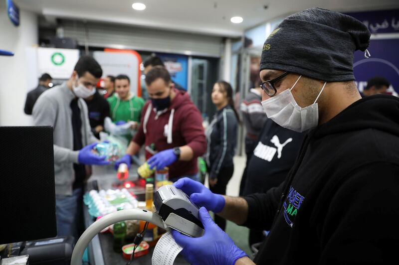 A cashier wearing a face mask amid concerns over the coronavirus (COVID-19) spread works at a mall in Amman, Jordan.REUTERS