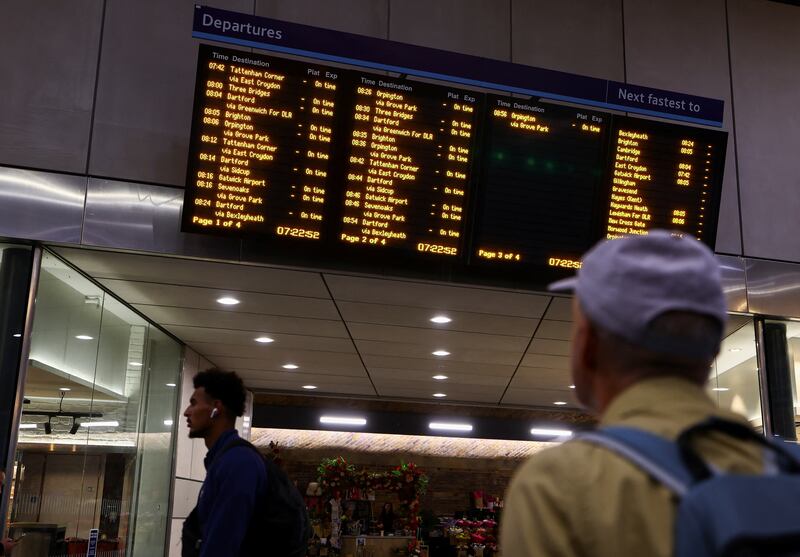 A commuter looks at the departure board at London Bridge. Reuters