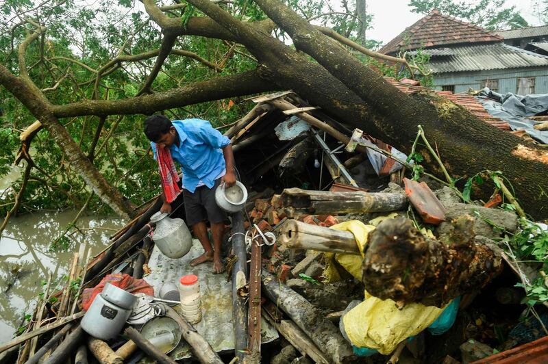 A man salvages items from his house damaged by cyclone Amphan in Midnapore, West Bengal.  AFP