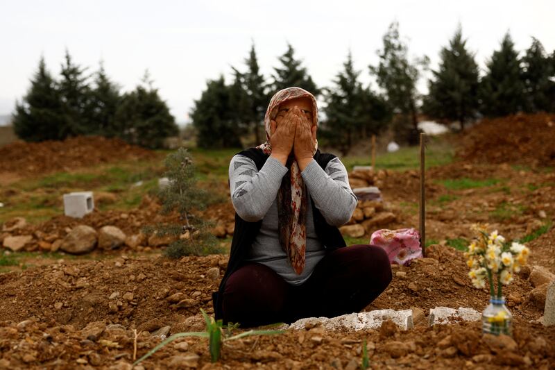 Emine Onal cries by the grave of her daughter, who was killed in the earthquake 15 days after having started her first job as a nurse in a Turkish state hospital. Reuters