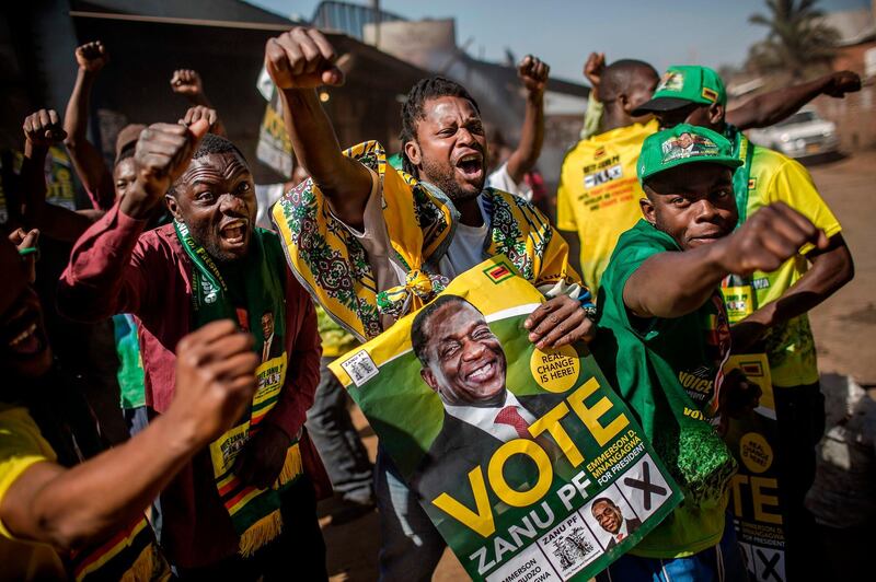 Supporters celebrate after Zimbabwe's President Emmerson Mnangagwa has been declared the winner in the country's landmark election, in the suburb of Mbare of Zimbabwe's capital Harare, on August 3, 2018.
President Emmerson Mnangagwa, who took power after veteran leader Mugabe was ousted late last year, was declared the winner of the presidential election on August 3 with 50.8 percent of the vote. / AFP PHOTO / Luis TATO