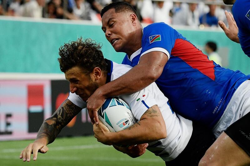 Italy full back Matteo Minozzi, left, dives and scores a try at the Hanazono Rugby Stadium. AFP