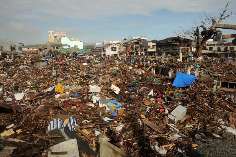 Typhoon Haiyan survivors participate in a “cash for work” programme, cleaning debris from houses in Tacloban, Leyte province. Noel Celis / AFP



