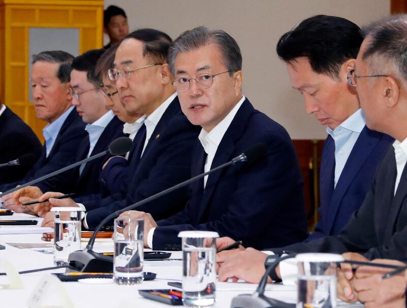 FILE - In this Wednesday, July 10, 2019, file photo, South Korean President Moon Jae-in, third from right, speaks during a meeting with business leaders at the presidential Blue House in Seoul, South Korea. Moon criticized comments by Japanese officials who questioned the credibility of Seoul's sanctions against North Korea while justifying Tokyo's move to strengthen controls on high-tech exports to South Korea. Moon said his government was committed to resolving the matter diplomatically and urged Japan to refrain from pushing the situation to a "dead-end street." (Bae Jae-man/Yonhap via AP, File)